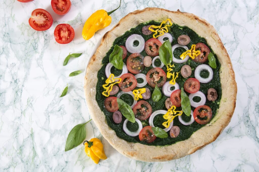 Vegan pizza with sautéed spinach and habanero peppers is a yummy and healthy recipe that delights with its vivacious colors and top flavor.